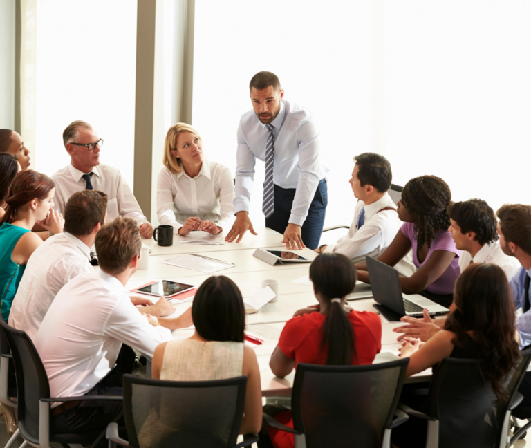 A business team engaged in a meeting around a conference table.